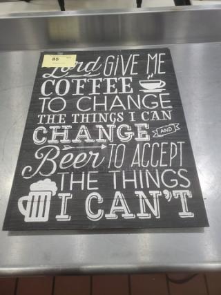 Decorative sign with text: "Lord give me coffee to change the things I can and beer to accept the things I can't." Black background, white lettering.