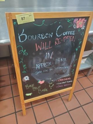 Wooden-framed chalkboard sign with "Bourbon Coffee Will Re-open" and menu items listed; fair condition.