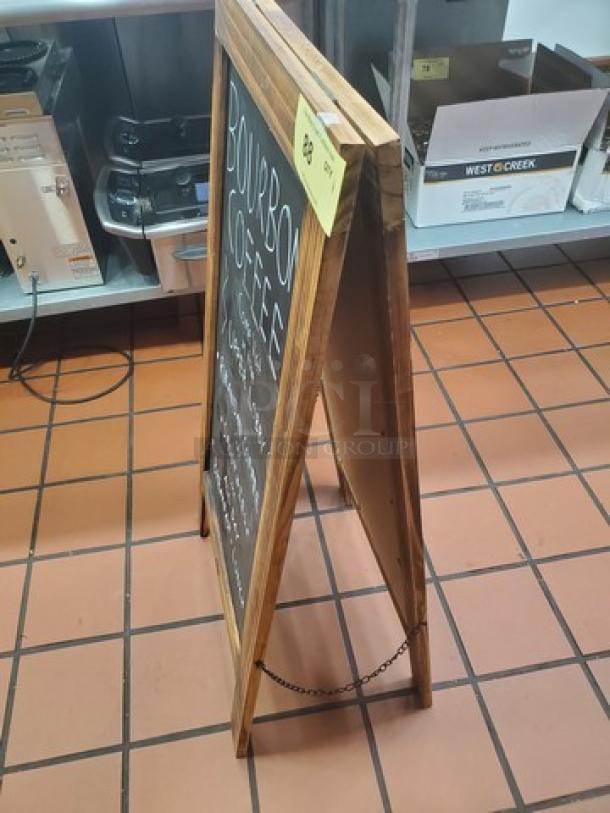 Wooden A-frame sign with chalkboard displaying "Bourbon Coffee" text. Sturdy, used condition with chain support.