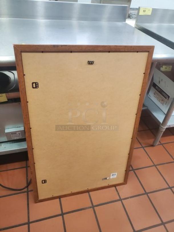 Wooden framed picture, rear view, measuring approx. 24x36 inches. Sturdy condition, mounting hooks visible, no visible artwork.