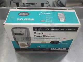 San Jamar Duett Tissue Dispenser in original box, for standard bath tissue. Box slightly worn, features brand and product info.