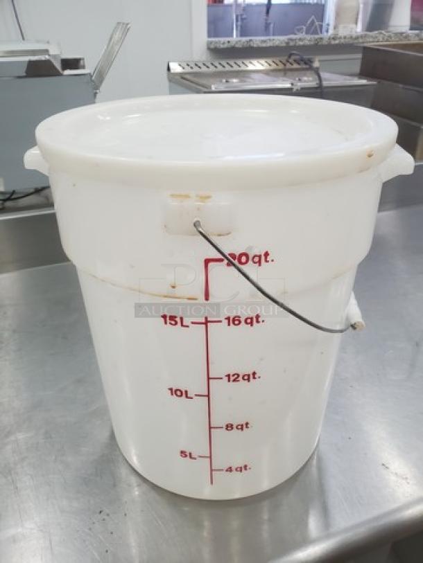 White 6-gallon beverage dispenser with red measurement markings in quarts. Features a lid and side handles. Used condition.