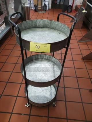 3 Tier Mobile Cart, metal construction, round trays, good condition, with handles and wheels for easy movement, auction tag visible.