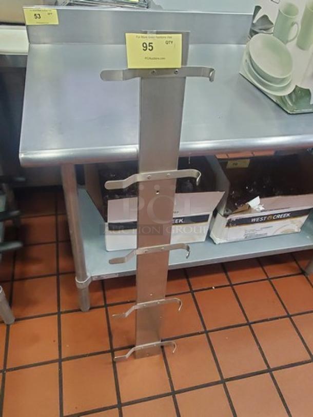 Stainless steel rack with four hooks, good condition, suitable for kitchen or storage, auction tag indicating item number 95.