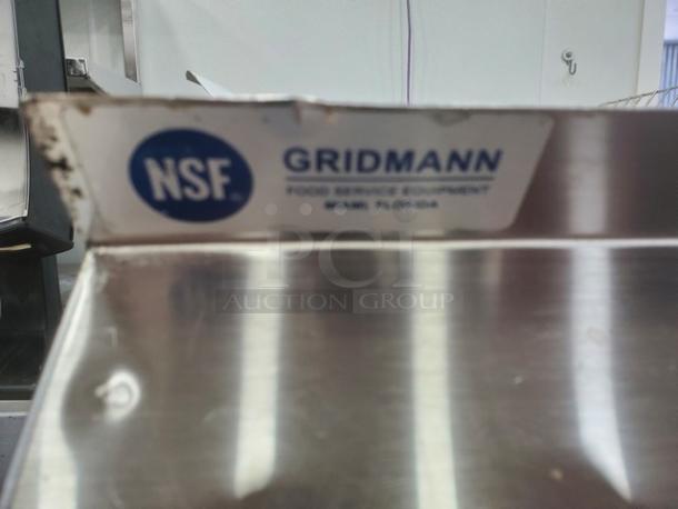 Gridmann stainless steel wall mount shelf with NSF label, Miami, Florida. Used condition with visible wear. Ideal for kitchens.
