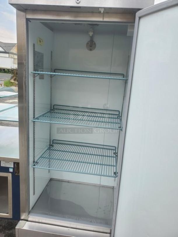 Avantco Solid Door Reach-In Freezer 178A19FHC, stainless steel, with three wire shelves, open door, in good condition.