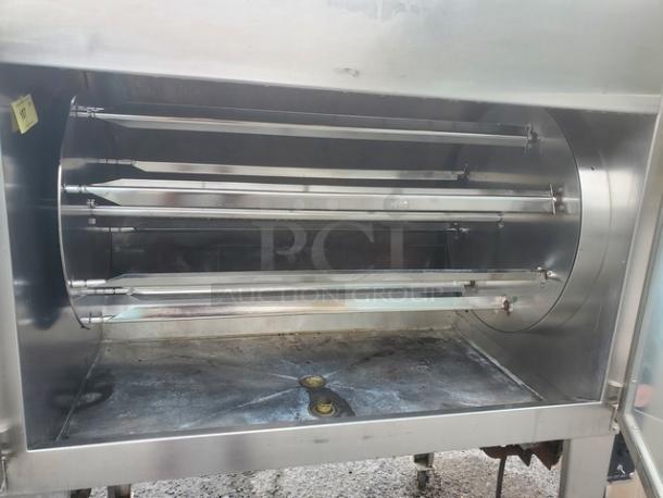 Hardt Inferno Natural Gas Rotisserie Oven, stainless steel, multiple spit racks, used condition, suitable for commercial use.