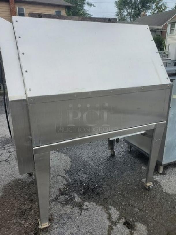Hardt Inferno natural gas rotisserie oven. Stainless steel, used condition, on wheels for mobility, model label not visible.