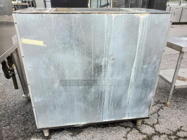 Manitowoc B-970 ice bin, 710 lb. capacity, stainless steel, visible wear and stains, sturdy build, model label intact.