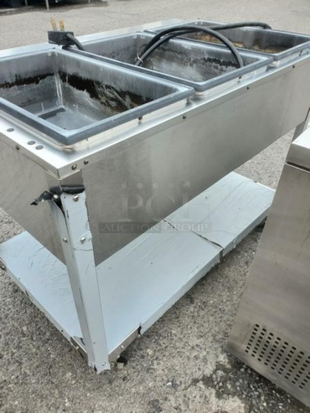 Vollrath 38213 ServeWell Hot Food Table with three stainless steel wells, showing signs of use, no visible labels.