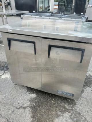 True TUC-36 undercounter refrigerator, stainless steel, dual-door, black handles, visible True logo, used condition.