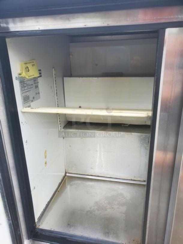 True TUC-36 undercounter refrigerator, stainless steel, single open door view, interior shelf, visible labeling, used condition.