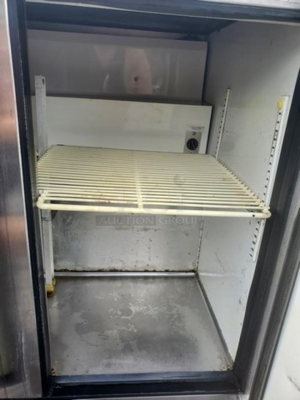 True TUC-36 undercounter refrigerator, showing interior with adjustable wire shelf, moderate wear, stainless steel finish.