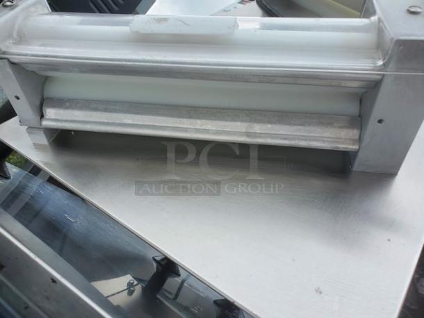DOYON DL12DP 12" countertop dough roller sheeter. Metal body, visible roller. Unknown condition, sold as is.