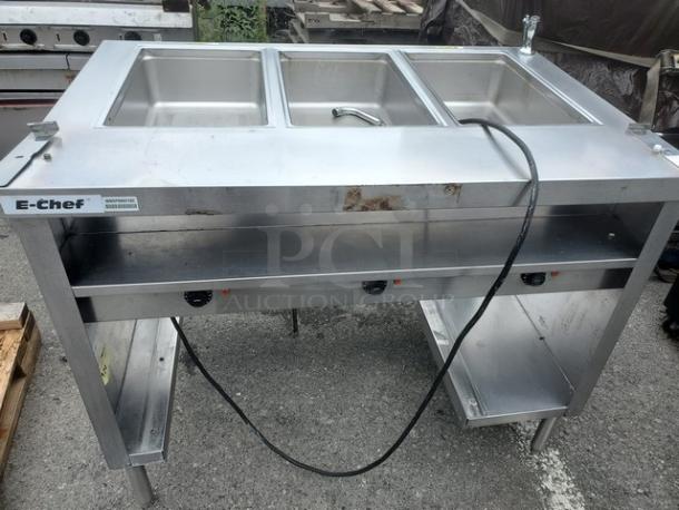 Delfield EHEI48C 48" hot food table, stainless steel, three compartments, visible wear, model and brand labels attached.