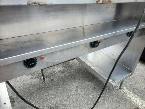 Delfield EHEI48C 48" hot food table, stainless steel, visible knobs, some wear, ideal for commercial use.