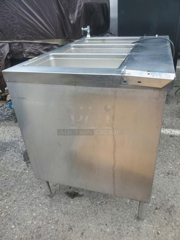Delfield EHEI48C 48" hot food table, stainless steel, four compartments, sturdy legs, used condition with visible wear.