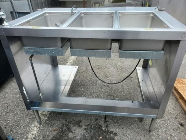 Delfield EHEI48C 48" hot food table in stainless steel, three compartments, good condition, visible wiring, metal frame.