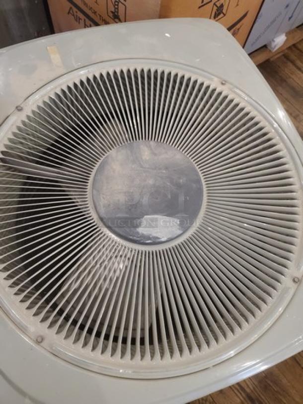 Central Air Conditioner Condenser model 2TWB3024A1000AA; visible fan grille; appears in good condition.