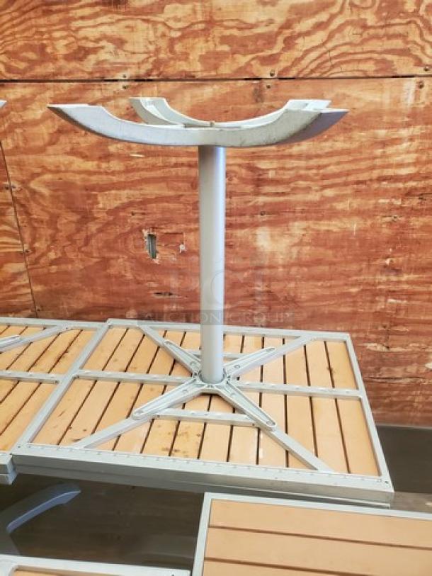 Square table top with metal base, wood slat design, good condition. Frame is silver metal; ideal for outdoor or patio use.