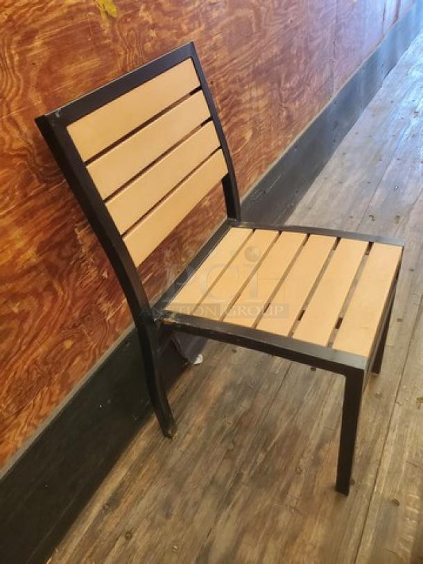 Lot of 4 patio chairs with black metal frame and wooden slats. Modern design, used condition.