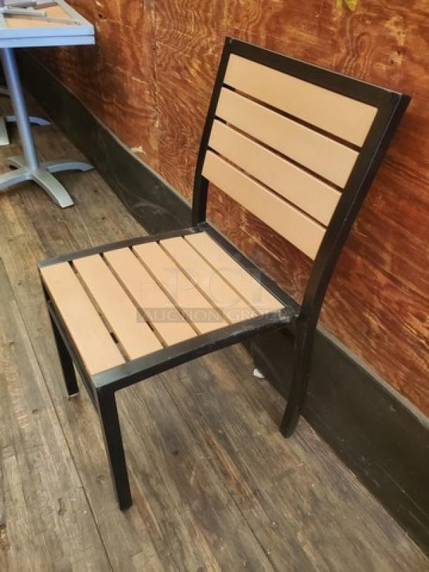 Black-framed patio chair with tan slatted seat and backrest. Modern design, weather-resistant materials. Part of a set of four.