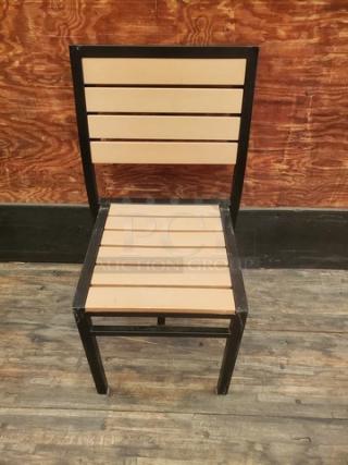 Lot of 4 patio chairs with black frames and light wooden slats. Good condition, modern design, durable materials.
