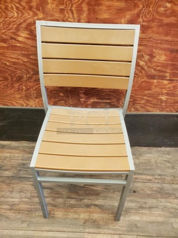 Set of 4 patio chairs with silver frames and light brown slatted backs and seats. Sturdy, modern design. Ideal for outdoor use.
