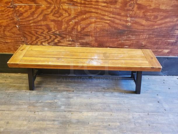 Lot of 2 wooden benches, solid wood with visible wear, slatted top design, sturdy black metal legs, rustic appearance.