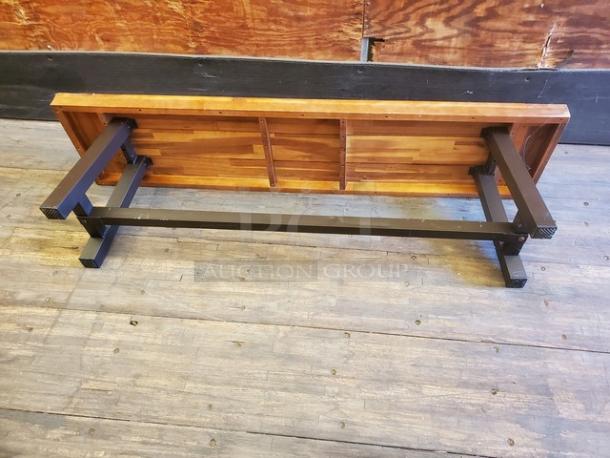 Lot of 2 wooden benches with black metal legs, featuring a natural wood grain finish. Appears in good condition.