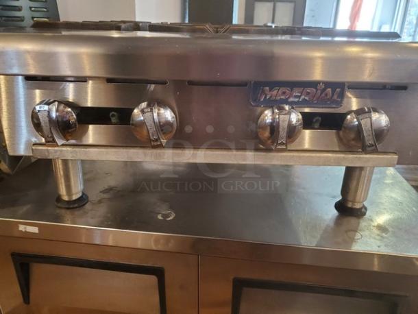 Imperial 4 Burner Range, stainless steel, with visible brand logo. Features four control knobs; good condition.
