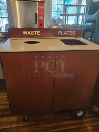 Wooden waste station featuring "Waste" and "Plates" labeled openings. Includes two cabinet doors and caster wheels.