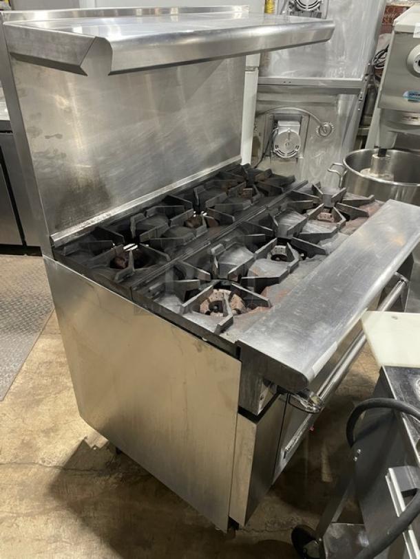 American Range commercial 6-burner stainless steel gas range/oven combo with backsplash, salamander shelf, and casters.