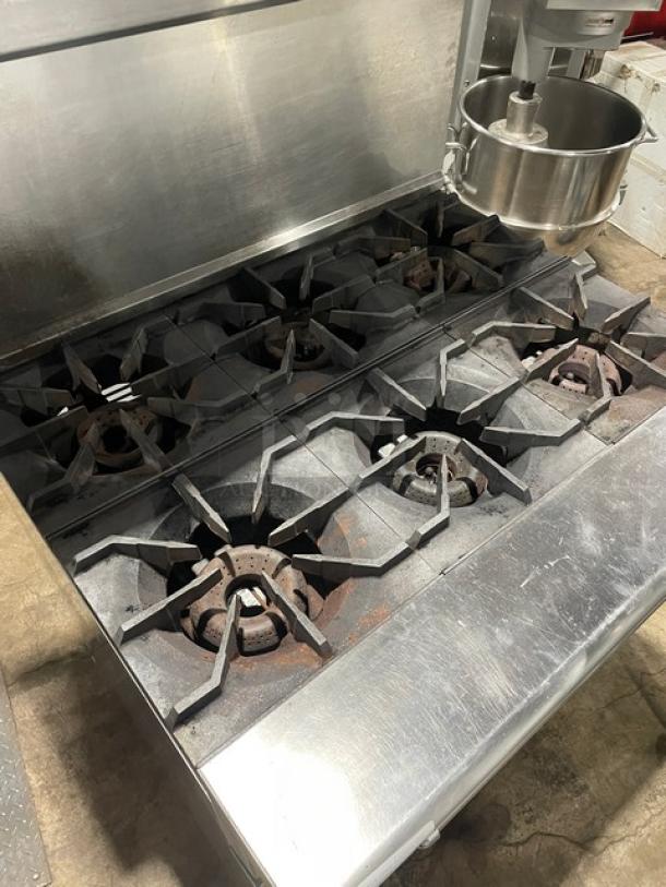 American Range commercial stainless steel 6-burner range/oven combo with back splash, overhead salamander shelf, and casters.