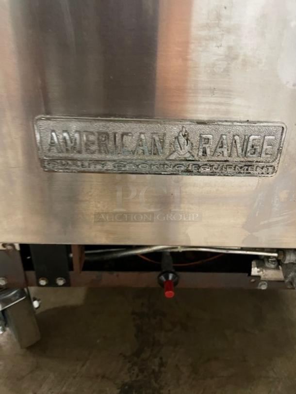 American Range commercial stainless steel 6-burner range/oven combo, natural gas powered, with backsplash, overhead salamander shelf, wired racks, on casters.