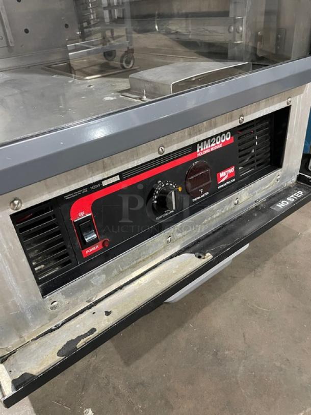 Metro C175-H(1)N heated holding/proofing cabinet with glass door, built-in pan slides, on casters, control panel detailed.
