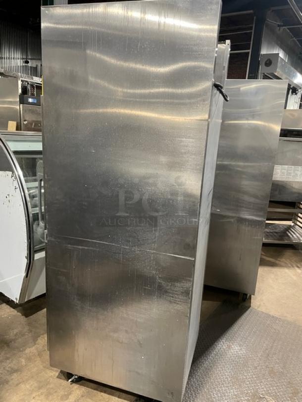 Traulsen stainless steel single glass door hot food merchandiser, model AW132N-X0001, on casters, with wire racks.