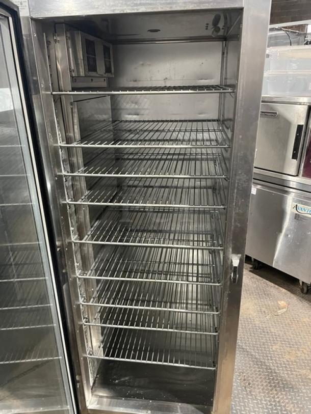 Traulsen Commercial Hot Food Merchandiser, Model AW132NX0001, stainless steel, glass swing door, includes wire racks, on casters.