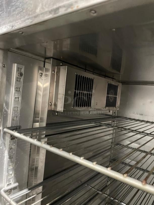 Traulsen stainless steel hot food merchandiser, model AW132NX0001, with wire racks, on casters. Interior view, excellent condition.