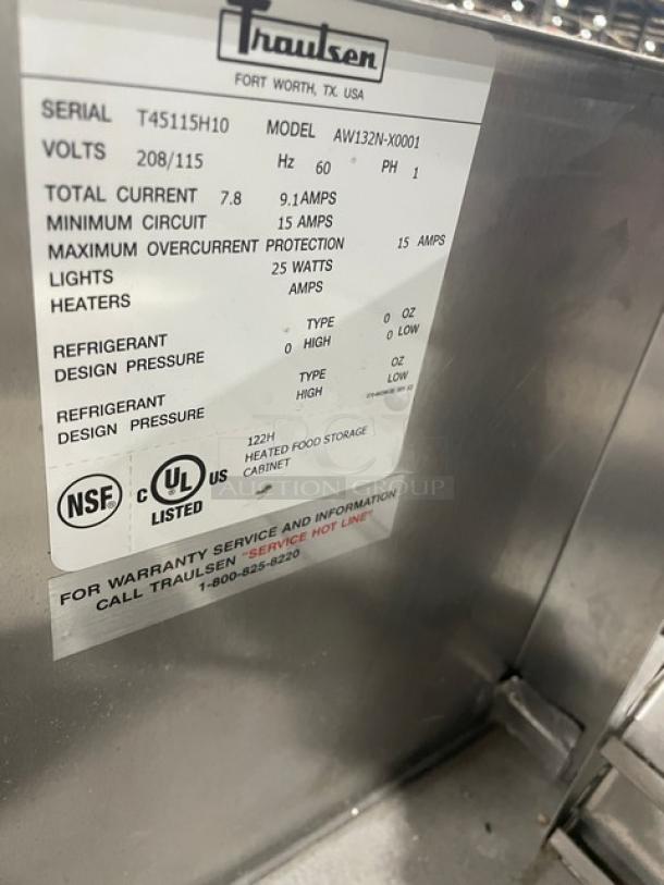 Traulsen stainless steel single glass door hot food merchandiser, model AW132N-X0001, on casters with wire racks.