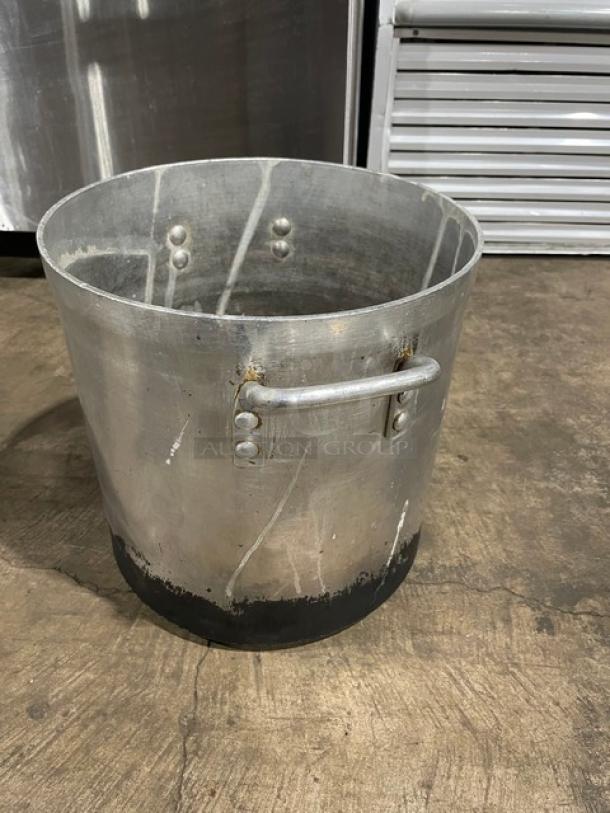 Heavy duty commercial stock pot with handles, metal finish, used condition, visible wear, sturdy construction.