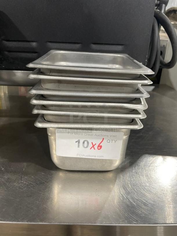 Stack of six commercial stainless steel hotel steamtable pans in good condition with label showing "10 x 6 QTY" from PCI Auctions.