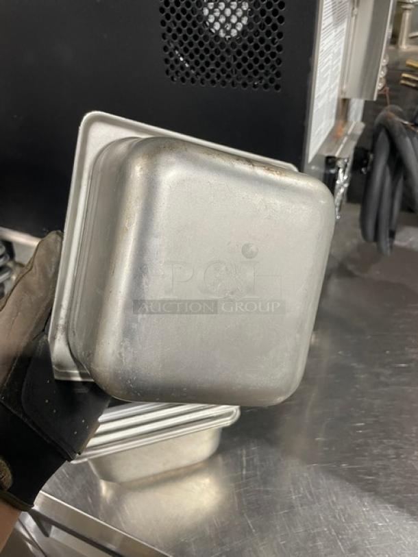 Commercial stainless steel hotel/steamtable pans. Sturdy, stackable design. Slight wear visible. Set of six for auction.