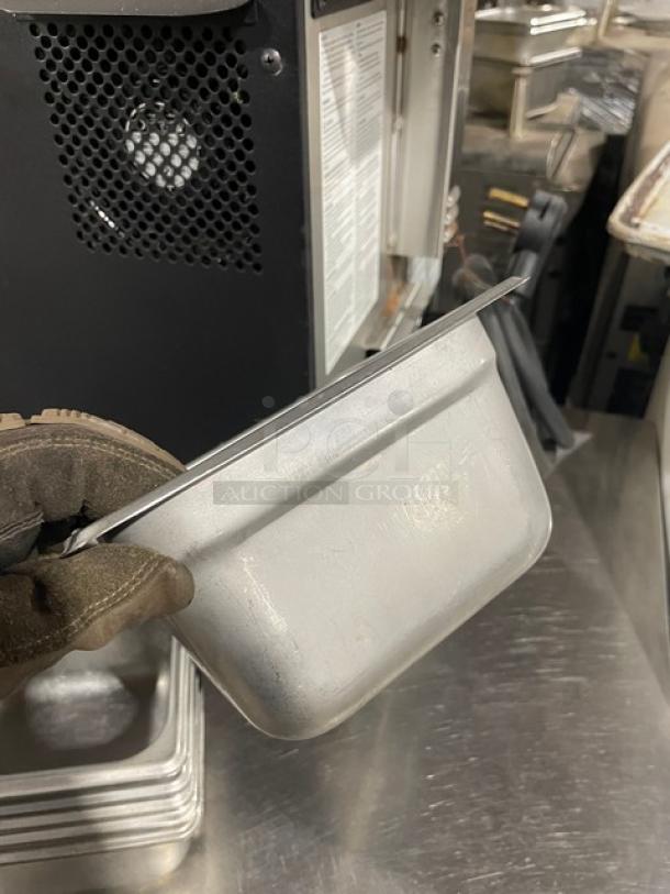 Commercial stainless steel hotel pan, gently used, rectangular, durable, suitable for steam tables, catering functions.