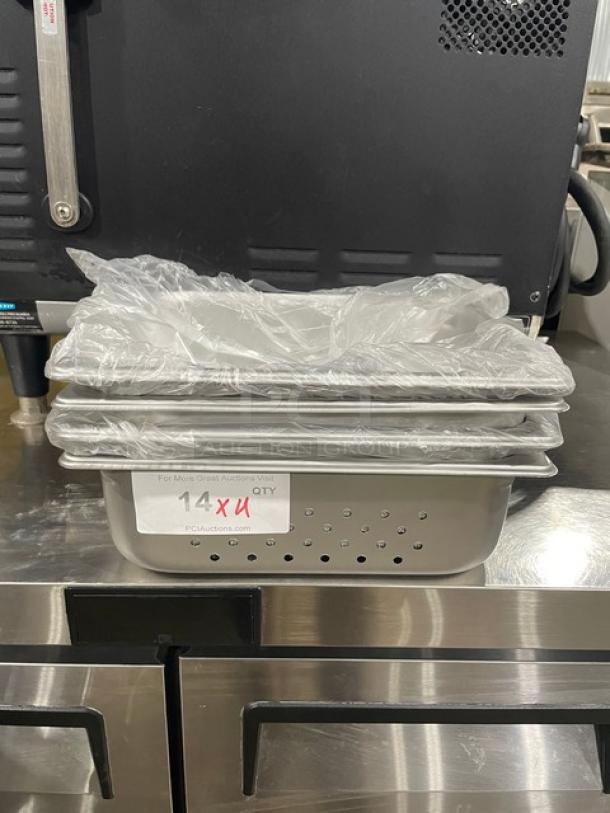 Production 125th stainless steel perforated hotel pans, model 880243. New condition, stack of pans with a protective cover.