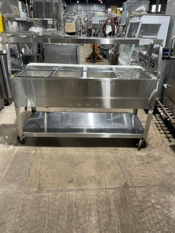 Duke Aero Hot Series EP304 electric 4-well steam table with sneeze guard, cutting board, single undershelf, on casters.