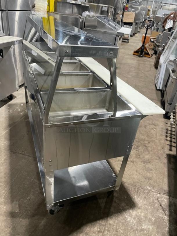 Duke Aero Hot Series EP304 stainless steel electric food/steam table, 4 wells, sneeze guard, cutting board, undershelf, on casters.