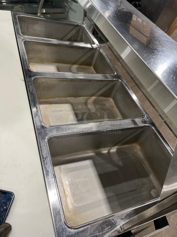 Duke Aero Hot Series EP304 stainless steel 4-well electric steam table with sneeze guard, cutting board, and undershelf on casters.