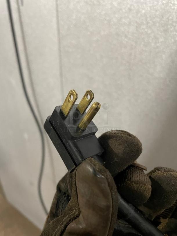 A Traulsen Spec Line commercial refrigerator plug, part of model AHT232WUT-HHS, shown in close-up.