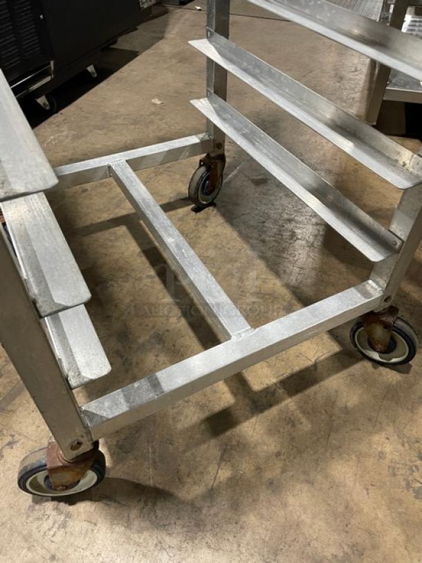 Alexander Industries heavy-duty bun/sheet pan transport rack on casters in used condition, showing minor wear.